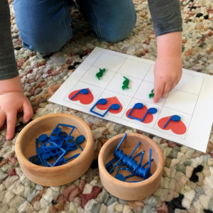 Young child plays with heartbeat chart on colour rug